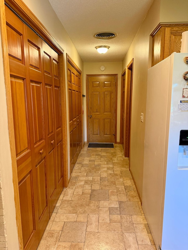 2705 6th St SW, Willmar, MN 56201 - hall featuring stone tile flooring and a textured ceiling