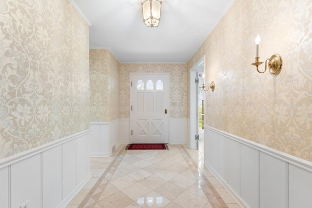 1429 20th St SW, Rochester, MN 55902 - entryway with wallpapered walls, inlaid floor details, wainscoting, a decorative wall, and ornamental molding