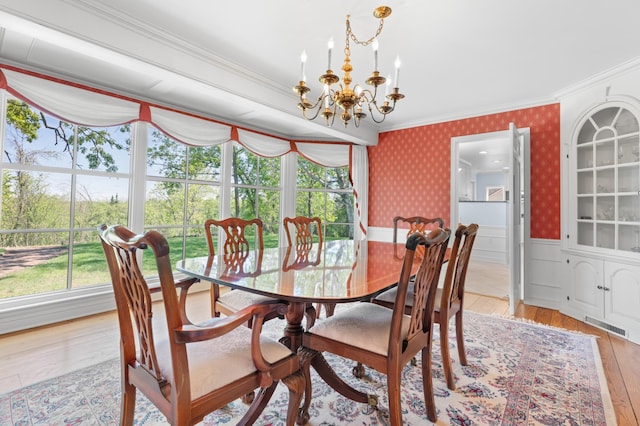 1429 20th St SW, Rochester, MN 55902 - dining space with a chandelier, ornamental molding, wainscoting, and light wood-style flooring