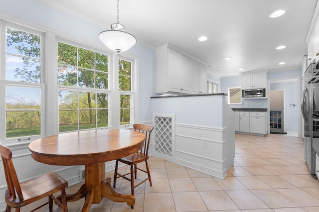 1429 20th St SW, Rochester, MN 55902 - dining room with light tile patterned floors, crown molding, beverage cooler, and recessed lighting