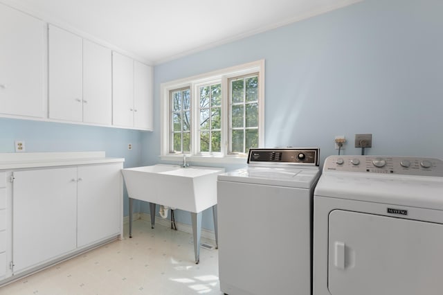 1429 20th St SW, Rochester, MN 55902 - washroom featuring washing machine and clothes dryer, cabinet space, light floors, and ornamental molding