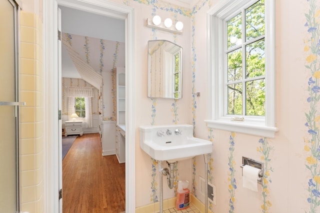 1429 20th St SW, Rochester, MN 55902 - full bath featuring wood finished floors, a shower with door, and wallpapered walls