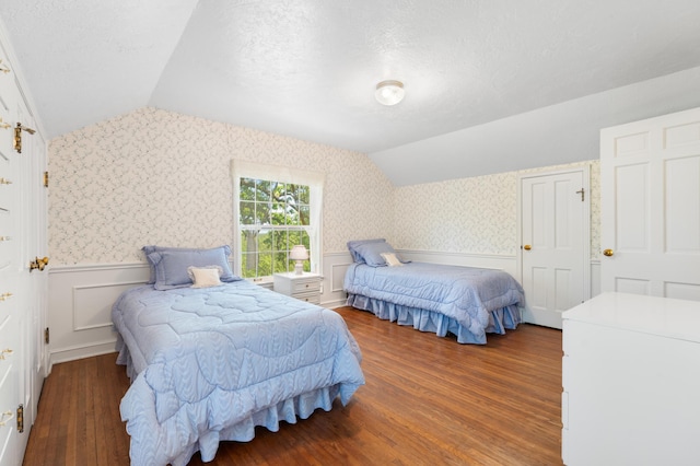 1429 20th St SW, Rochester, MN 55902 - bedroom featuring lofted ceiling, wallpapered walls, wood finished floors, wainscoting, and a textured ceiling