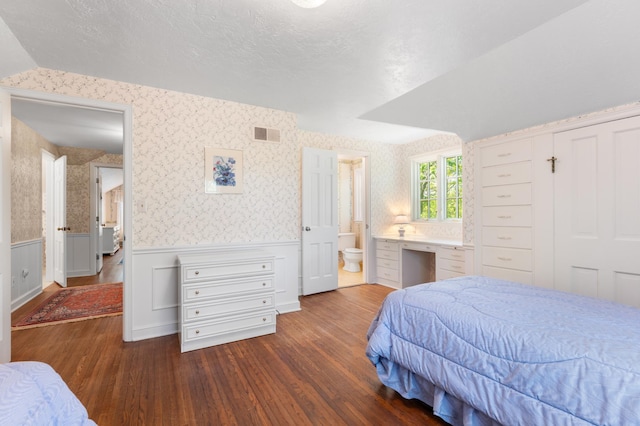 1429 20th St SW, Rochester, MN 55902 - bedroom with wood finished floors, wainscoting, wallpapered walls, and connected bathroom