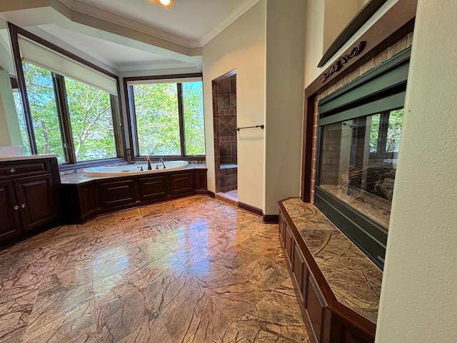 full bathroom with ornamental molding, plenty of natural light, a bath, and a tile shower