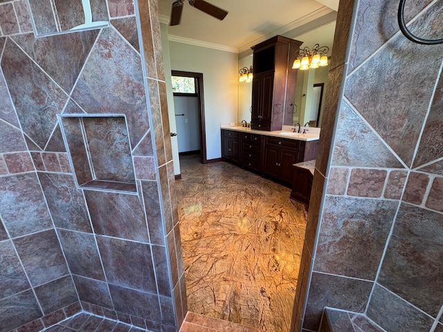 bathroom with crown molding, double vanity, walk in shower, ceiling fan, and baseboards