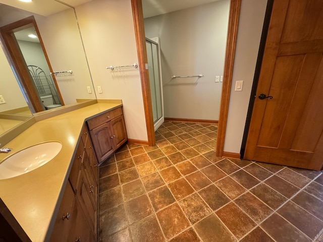 bathroom featuring baseboards, a shower stall, vanity, and recessed lighting