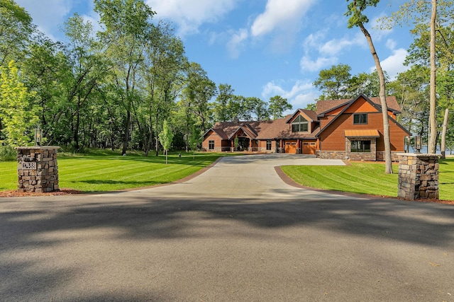 17488 Alexander Ct, Cold Spring, MN 56320 - view of front of home featuring stone siding, asphalt driveway, and a front lawn