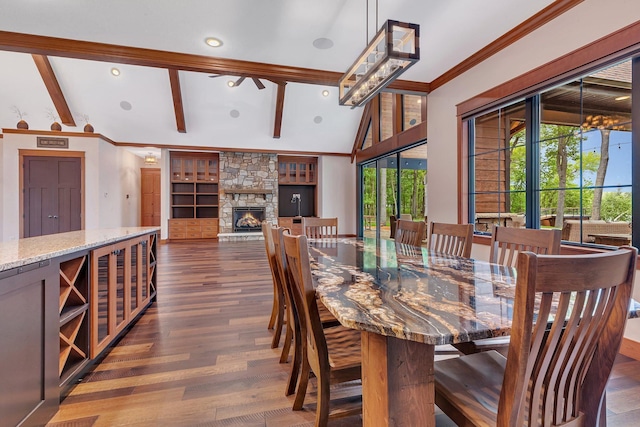 17488 Alexander Ct, Cold Spring, MN 56320 - dining room featuring dark wood-style floors, beamed ceiling, a stone fireplace, built in shelves, and high vaulted ceiling