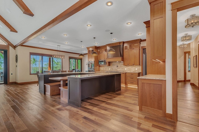 17488 Alexander Ct, Cold Spring, MN 56320 - kitchen featuring a large island with sink, baseboards, backsplash, premium range hood, and a chandelier