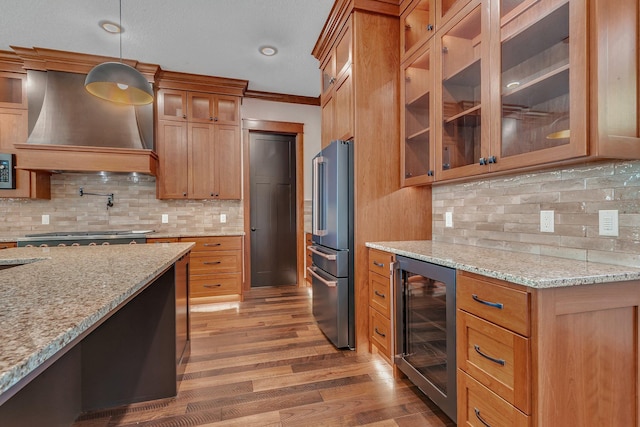 17488 Alexander Ct, Cold Spring, MN 56320 - kitchen featuring beverage cooler, custom exhaust hood, appliances with stainless steel finishes, brown cabinets, and light wood-style flooring