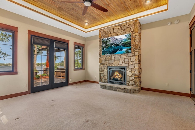 17488 Alexander Ct, Cold Spring, MN 56320 - unfurnished living room with wood ceiling, a tray ceiling, carpet floors, and baseboards