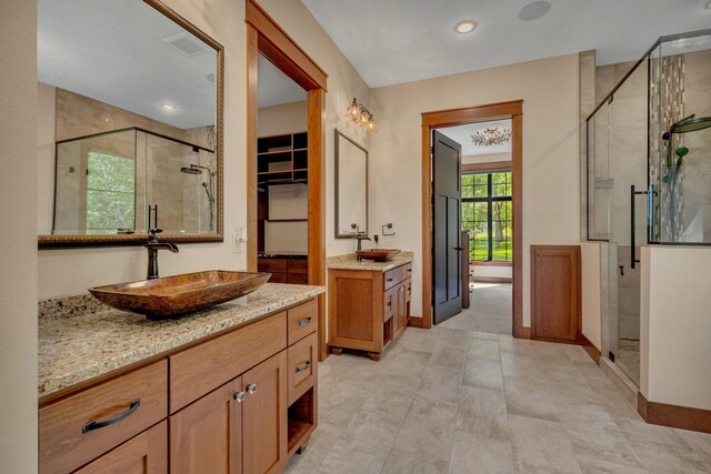 17488 Alexander Ct, Cold Spring, MN 56320 - full bath featuring a shower stall, two vanities, and baseboards