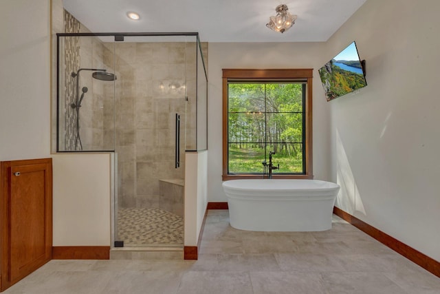 17488 Alexander Ct, Cold Spring, MN 56320 - bathroom featuring baseboards, a shower stall, and a soaking tub