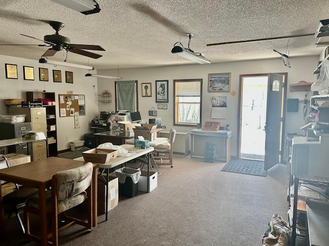 carpeted dining area featuring a ceiling fan, a textured ceiling, and baseboards