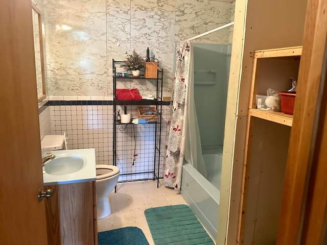 full bathroom featuring wallpapered walls, toilet, tile patterned floors, shower / bath combo with shower curtain, and vanity