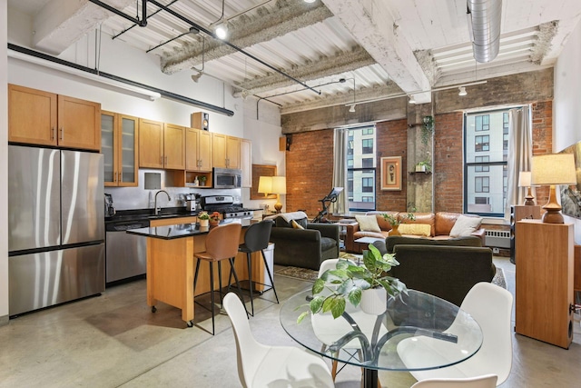 dining room with brick wall, a high ceiling, concrete flooring, and beamed ceiling