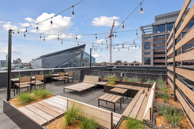 wooden terrace with outdoor lounge area and a view of city