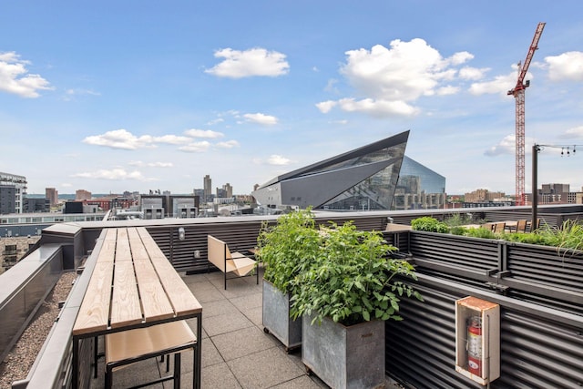 view of patio with a view of city and a balcony