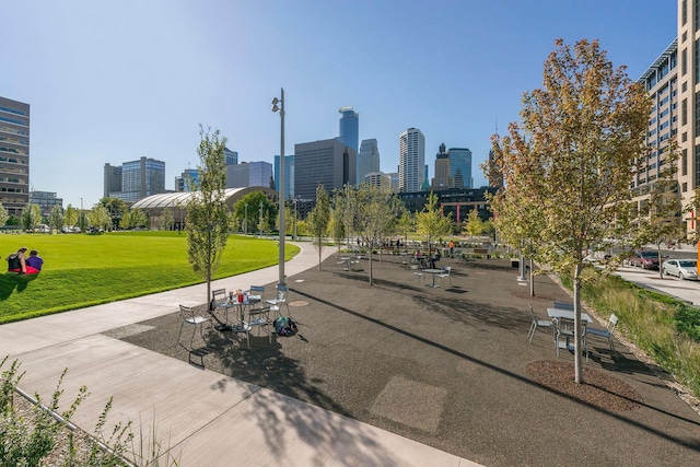 view of community featuring a skyline view and a yard