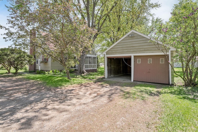 detached garage with dirt driveway