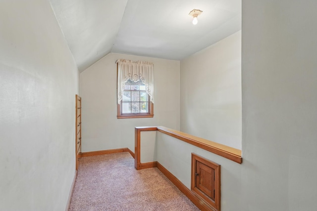 bonus room with light carpet, lofted ceiling, and baseboards