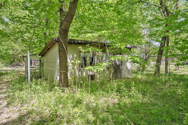 view of property exterior featuring fence