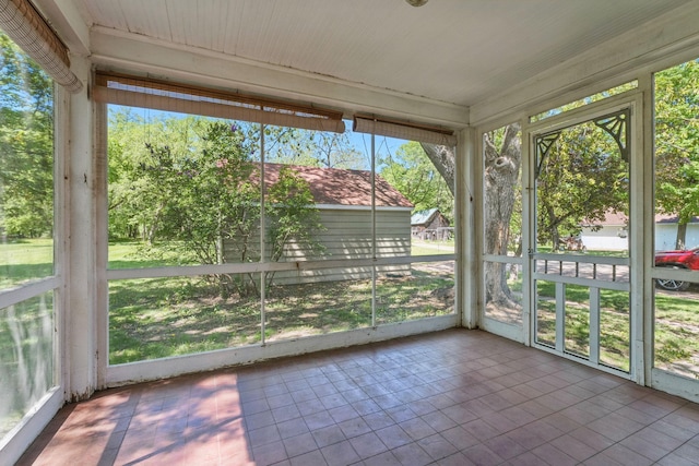 unfurnished sunroom with plenty of natural light