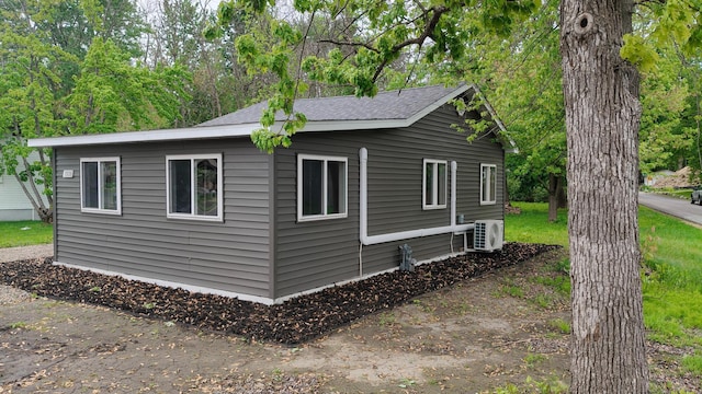 1808 Beach Dr SE, Forest Lake, MN 55025 - view of property exterior featuring ac unit and a shingled roof