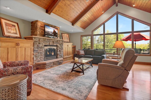 19336 Koetter Ct, Richmond, MN 56368 - living area with a stone fireplace, hardwood / wood-style floors, beamed ceiling, wooden ceiling, and baseboards