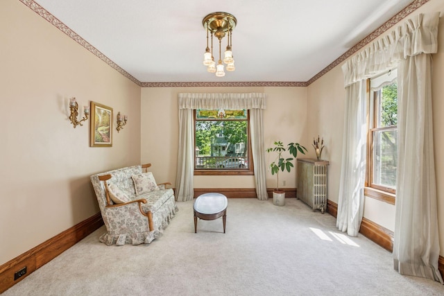 716 4th St NE, Minneapolis, MN 55413 - living area featuring carpet, healthy amount of natural light, a chandelier, and ornamental molding