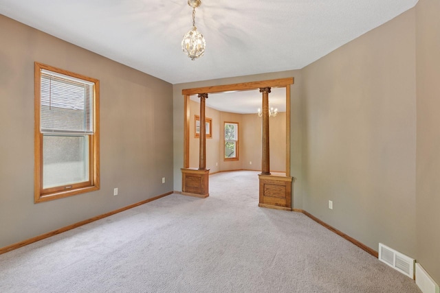716 4th St NE, Minneapolis, MN 55413 - empty room featuring a chandelier, light carpet, and baseboards