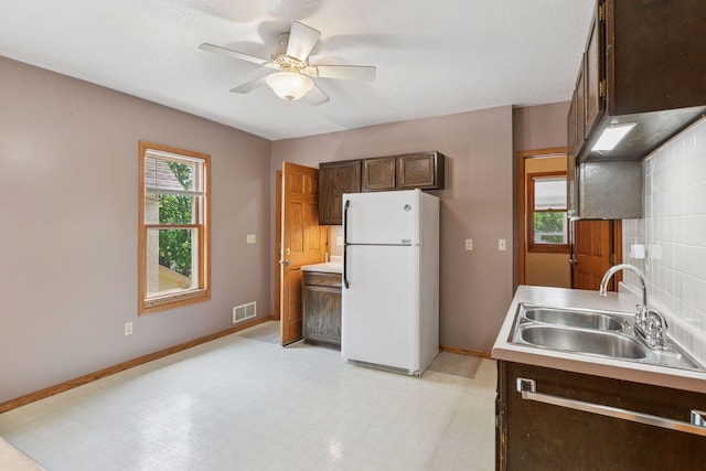716 4th St NE, Minneapolis, MN 55413 - kitchen with freestanding refrigerator, a sink, baseboards, a ceiling fan, and light countertops