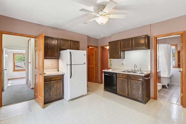 716 4th St NE, Minneapolis, MN 55413 - kitchen featuring freestanding refrigerator, black dishwasher, a sink, light countertops, and dark brown cabinetry