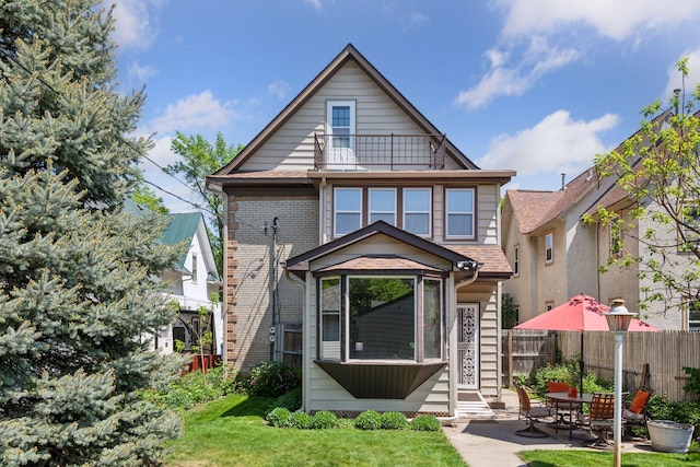 716 4th St NE, Minneapolis, MN 55413 - view of front of property with a balcony, entry steps, a patio area, and brick siding