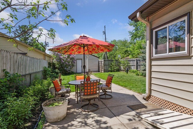 716 4th St NE, Minneapolis, MN 55413 - view of patio / terrace with outdoor dining space and an outbuilding