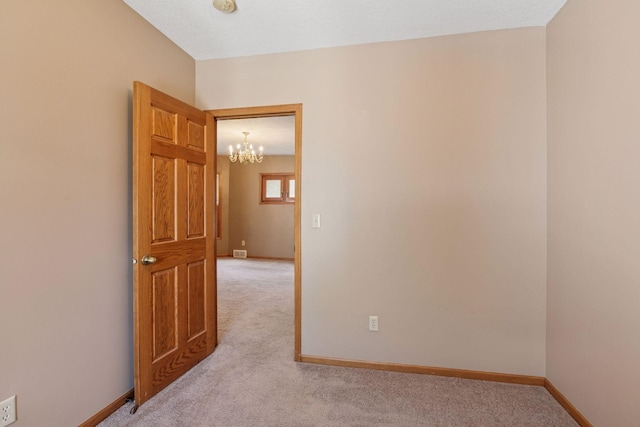 716 4th St NE, Minneapolis, MN 55413 - empty room featuring light carpet, a chandelier, and baseboards