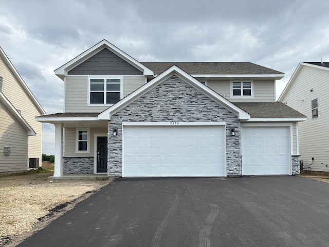 7370 184th St W, Lakeville, MN 55044 - view of front of property featuring driveway, stone siding, and a shingled roof