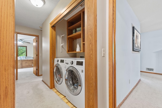 9553 Woodridge Cir, Eden Prairie, MN 55347 - washroom with light carpet, washing machine and dryer, baseboards, and a textured ceiling