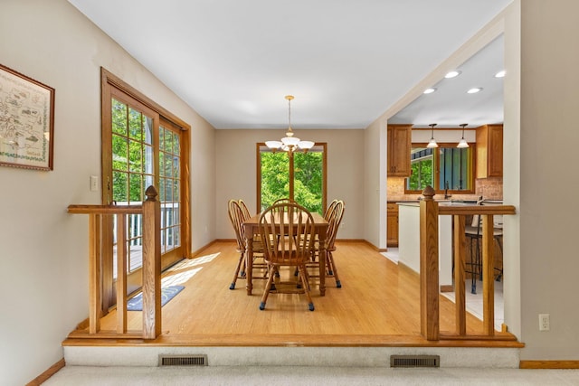 9553 Woodridge Cir, Eden Prairie, MN 55347 - dining space featuring a chandelier, baseboards, recessed lighting, and light wood finished floors