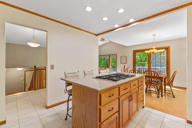 9553 Woodridge Cir, Eden Prairie, MN 55347 - kitchen with stainless steel gas stovetop, light tile patterned floors, baseboards, a breakfast bar area, and ceiling fan