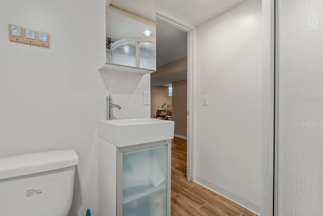 2532 Upton Ave S, Minneapolis, MN 55405 - bathroom featuring toilet, wood finished floors, baseboards, and vanity