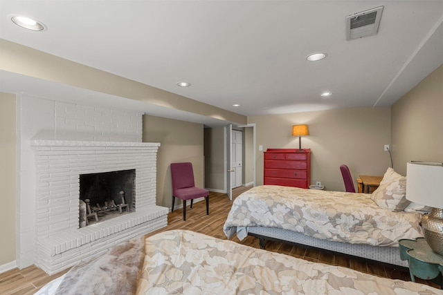 2532 Upton Ave S, Minneapolis, MN 55405 - bedroom featuring wood finished floors, baseboards, recessed lighting, and a brick fireplace