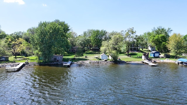 dock area featuring a water view and view of wooded area