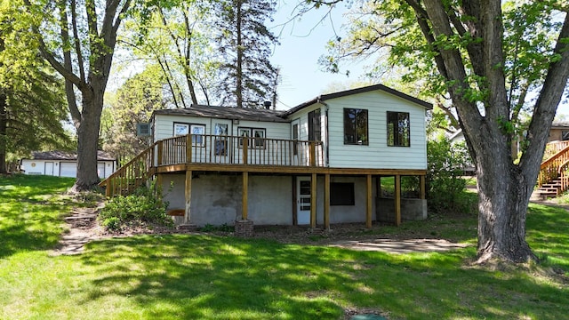 back of property featuring stairs, a deck, and a lawn