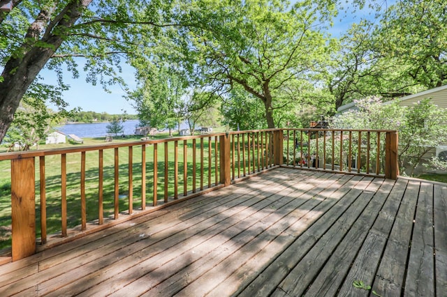 deck featuring a water view and a yard