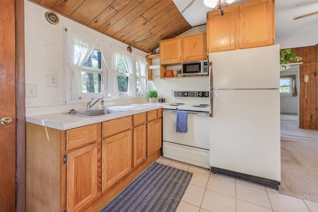 kitchen featuring white appliances, a sink, vaulted ceiling, wood ceiling, and light countertops