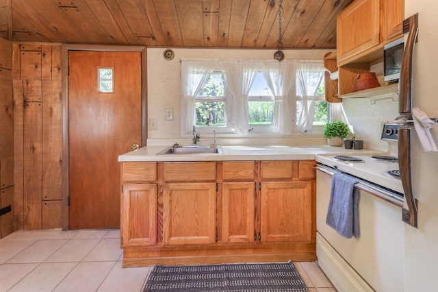 kitchen featuring white range with electric stovetop, a sink, wooden ceiling, light countertops, and light tile patterned floors