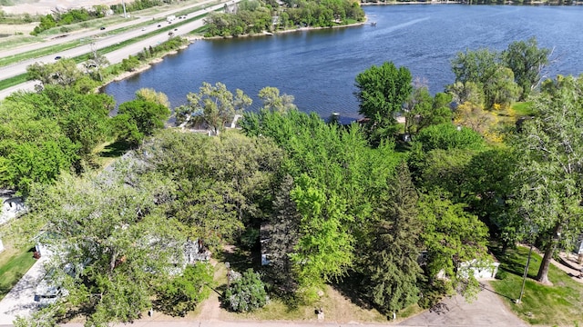 aerial overview of property's location with a nearby body of water and a tree filled landscape