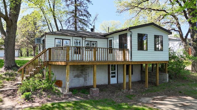 rear view of house with a wooden deck and stairs